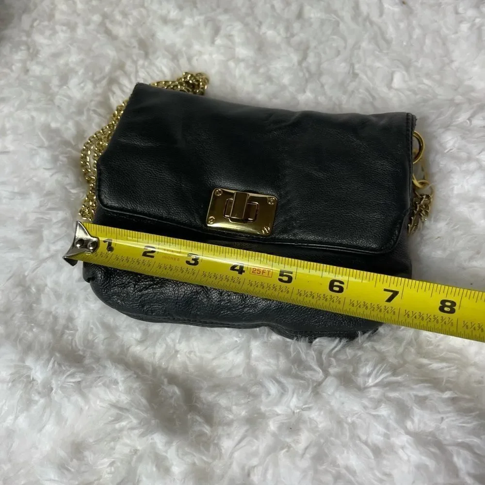 Paradox leather black small crossbody bag with ajustable gold tone chain.